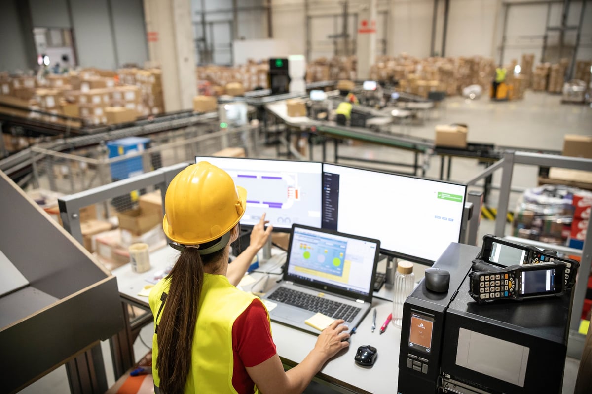 Woman analyzing real-time data in a warehouse