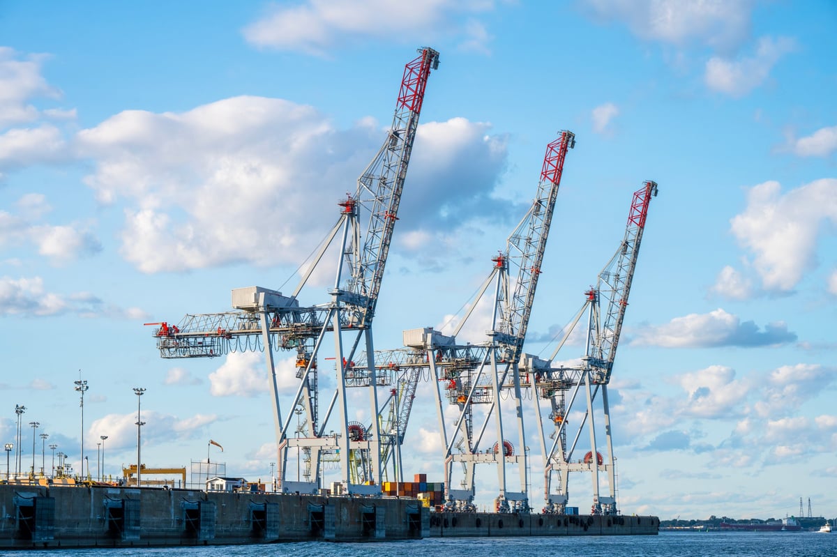 Port cranes handling containers and goods