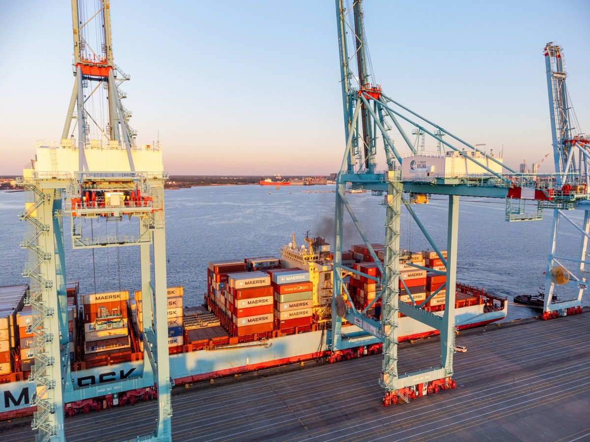 Massive cranes unloading cargo containers at port
