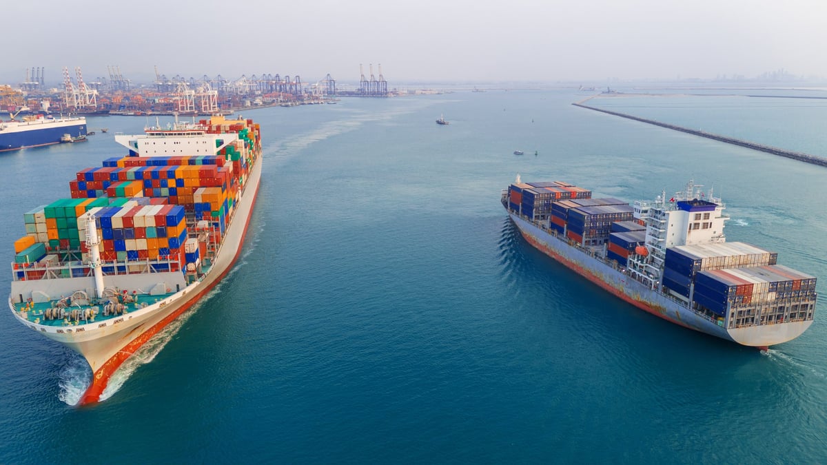 Container ships navigating a busy port channel
